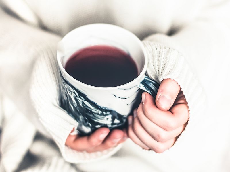 calm and quiet loving solopreneur enjoying a relaxing moment of self care with a cup of tea